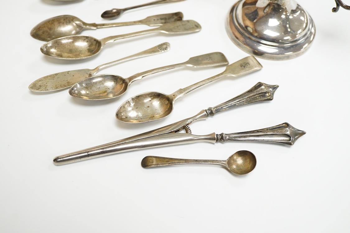 A small group of silver including a modern two branch, three light dwarf candelabrum by Sanders & Mackenzie, height 10.2cm, weighted, a pair of handled glove stretchers and eight small items of flatware.